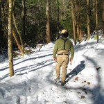 Ian walks a snowy trail along the stream in the Smokies